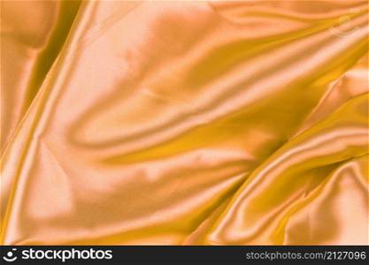 Gold wrinkled cloth background for design in your work concept.