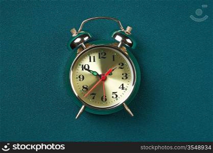 golden alarm clock on the background of cloth