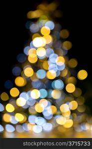 Golden and blue christmas lights illuminated Background tree