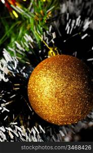golden ball on christmas tree, close-up view, shallow DoF