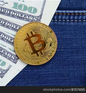 Golden Bitcoin and dollar bills lies on a blue jeans fabric. New virtual money. New crypto currency in the form of the coins