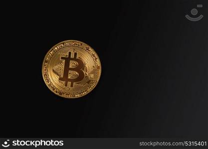 Golden Bitcoin coin. Golden Bitcoin coin on the black background