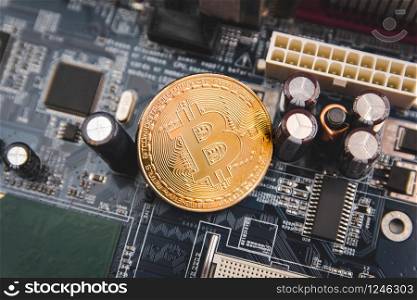 Golden Bitcoin coins on Motherboard, miner with circuit board, pool Cryptocurrency