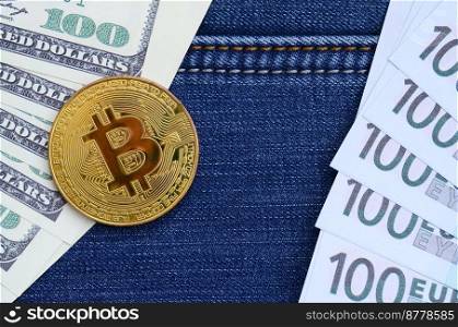 Golden Bitcoin, dollar and euro bills lies on a blue jeans fabric. New virtual money. New crypto currency in the form of the coins