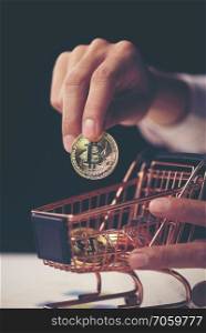 Golden Bitcoin in a man hand, Digitall symbol of a new virtual currency