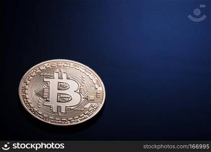 Golden bitcoin on a dark blue background. The concept of virtual business and currency.. Golden bitcoin on a dark blue background