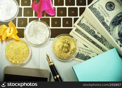 Golden bitcoins and money on laptop. Cryptocurrency and mining concept.
