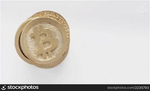 golden bitcoins stacked white background