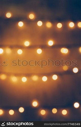 Golden Bokeh Abstract Background. Holiday Spirit Blurred Decor. Christmas Tree Glowing Lights.. Vintage Background of Christmas Lights