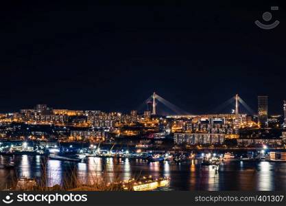 Golden bridge in Vladivostok at night.. Night view of the city of Vladivostok. Vladivostok, Russia.