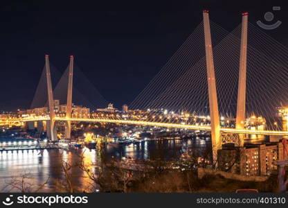 Golden bridge in Vladivostok at night.. Night view of the city of Vladivostok. Vladivostok, Russia.