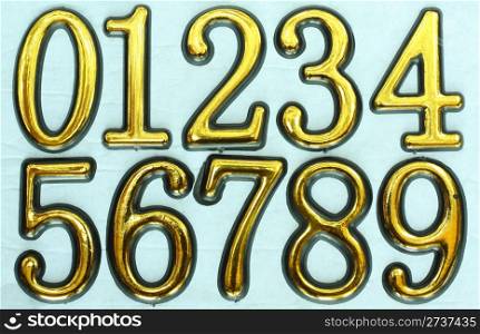 Golden bright numbers on a light blue background. Numbers 0, 1, 2, 3, 4, 5, 6, 7, 8 and 9.