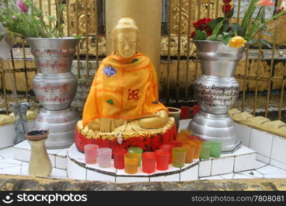 Golden Buddha and shrine near stupa in buddhist monastery, Yangon, Myanmar