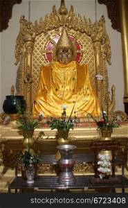 Golden Buddha at night in Buddha&rsquo;s Hair psagoda, Yangon, Myanmar