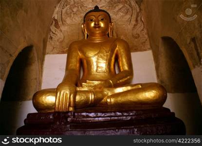 Golden Buddha in old temple in Bagan, Myanmar