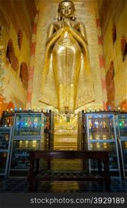 Golden Buddha Kakusandha standing inside of Ananda temple in Bagan, Myanmar.