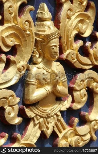 Golden Buddha on the wall of temple in wat Hualampong, Bangkok, Thailand