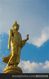 Golden buddha statue with blue sky, Roi Et Thailand