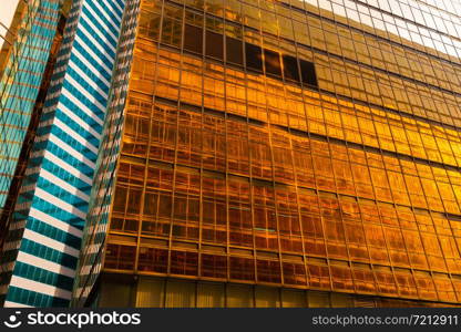 Golden building. Windows glass of modern office skyscrapers in technology and business concept. Facade design. Construction structure of architecture or engineering. Exterior for urban city background