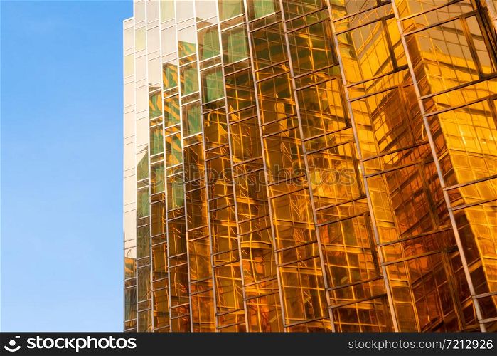 Golden building. Windows glass of modern office skyscrapers in technology and business concept. Facade design. Construction structure of architecture or engineering. Exterior for urban city background