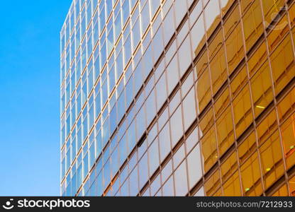 Golden building. Windows glass of modern office skyscrapers in technology and business concept. Facade design. Construction structure of architecture or engineering. Exterior for urban city background