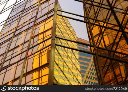 Golden building. Windows glass of modern office skyscrapers in technology and business concept. Facade design. Construction structure of architecture or engineering. Exterior for urban city background