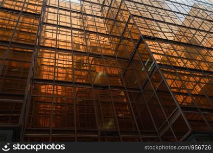 Golden building. Windows glass of modern office skyscrapers in technology and business concept. Facade design. Construction structure of architecture exterior for urban cityscape background.