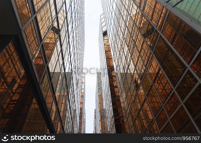 Golden building. Windows glass of modern office skyscrapers in technology and business concept. Facade design. Construction structure of architecture exterior for urban cityscape background.