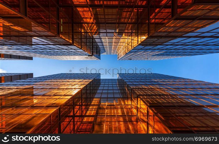 Golden building with blue sky. Windows glass of modern office skyscrapers. facade design. Architecture exterior for cityscape background.