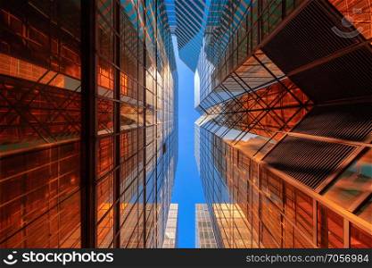 Golden building with blue sky. Windows glass of modern office skyscrapers. facade design. Architecture exterior for cityscape background.
