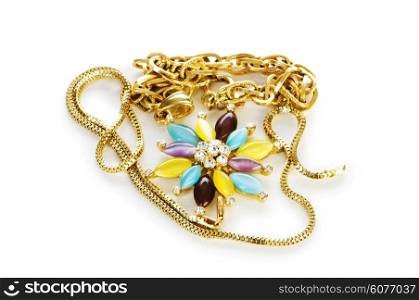 Golden chain and brooch isolated on white