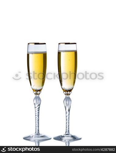 Golden champagne in elegant glasses isolated over white background with reflection