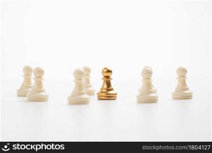 Golden chess pawn standing with the team to show influence and empowerment. Concept of business leadership for leader team, successful competition winner and Leader with influence