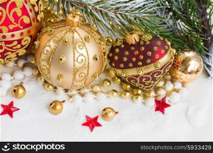 golden christmas ball and red heart with evegreen tree in snow . golden christmas bow and evegreen tree