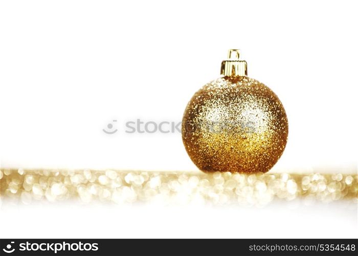Golden christmas ball on glitter background with white copy space