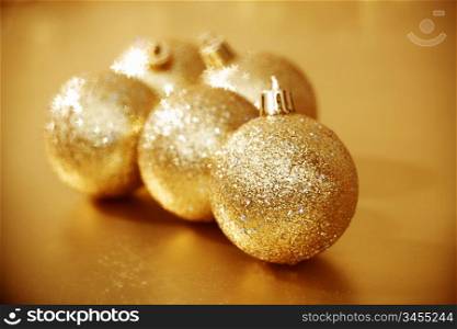 golden christmas ball on golden star bokeh background
