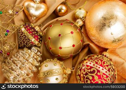 golden christmas ball. set of golden and red christmas decoration on soft silk background