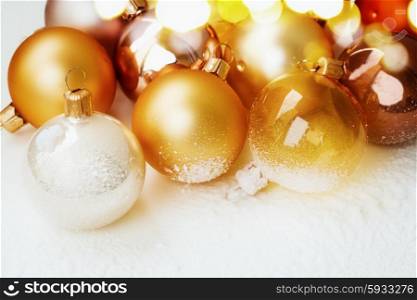 golden christmas balls on snow white background, retro toned