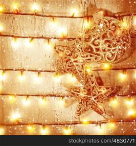 Golden Christmas baubles hanging on wooden door, decorated with glittering garland, New Year eve magic, beautiful Xmas still life, glowing background