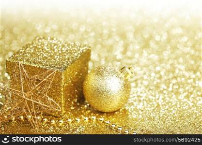 Golden christmas decor and gift on glitter background with white copy space
