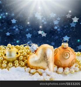 golden christmas decorations on blue background with stars. golden christmas decorations