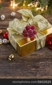 golden christmas gift box with lights in background. christmas decorations with gift box