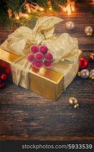 golden christmas gift box with lights in background, retro toned