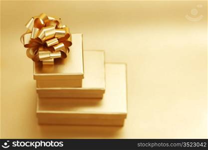 golden christmas gifts on gold background