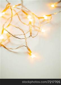 golden christmas lights on white holiday background