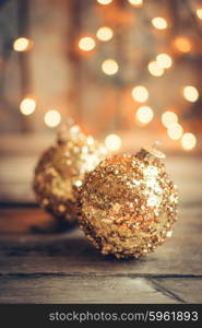 Golden christmas ornaments on rustic background