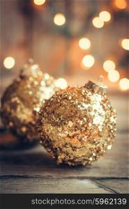 Golden christmas ornaments on rustic background