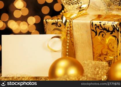 golden christmas present with christmas balls. golden christmas present with christmas balls and a gift card