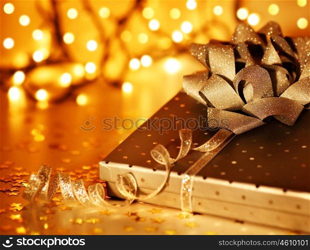 Golden Christmas tree ornament and holiday decoration with gift box &amp; blur lights