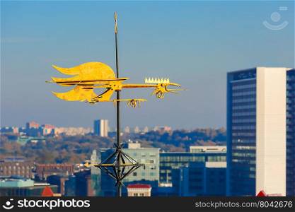 Golden Cockerel weather vane and modern office buildings skyscrapers in the background in Tallinn in the day, Estonia